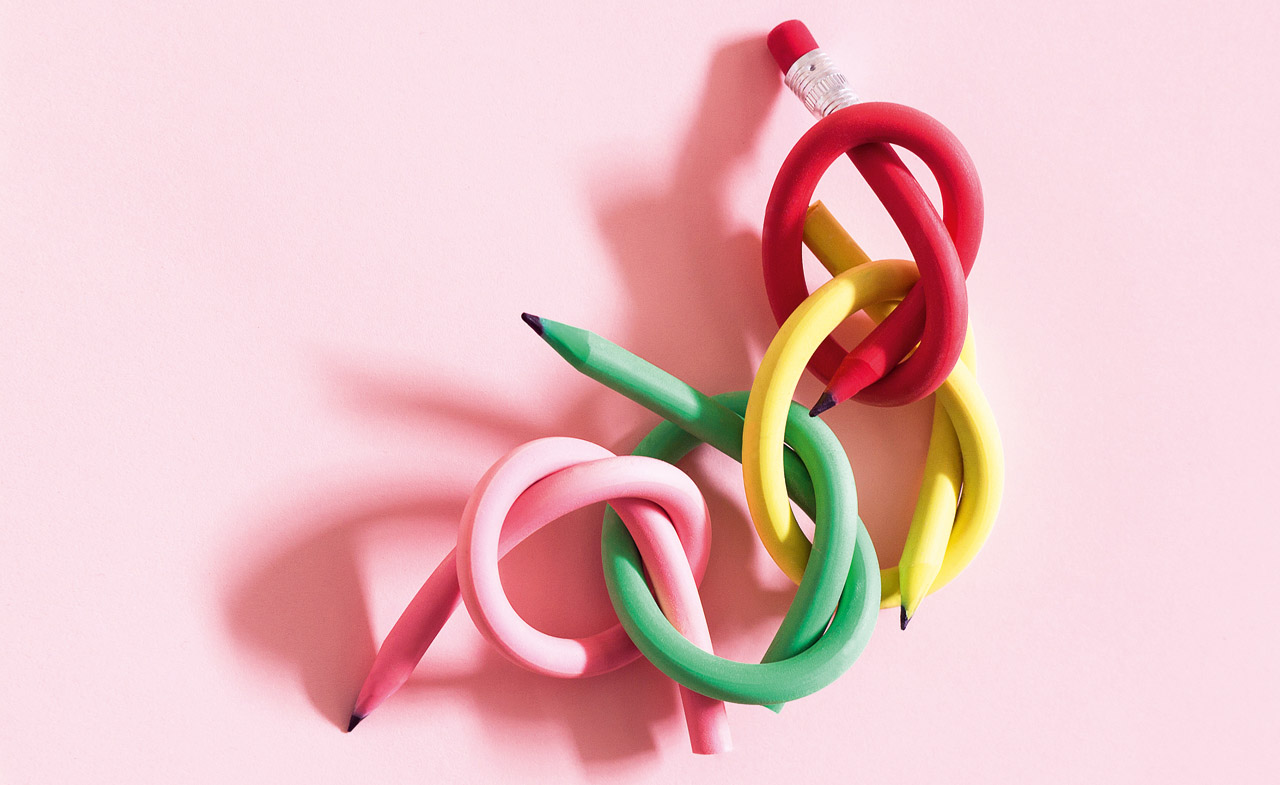 Colored pencils tied up in a knot